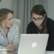 Two-women-looking-shocked-by-a-computer